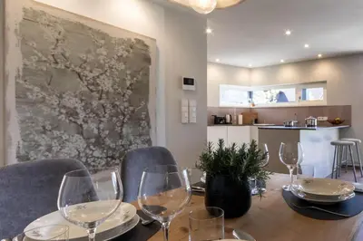 a dining room with a table with wine glasses at Mali Apartments Garden Suite in Tirolo
