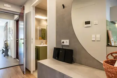 a living room with a tv and a mirror on the wall at Mali Apartments Lounge in Tirolo