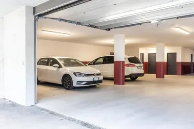 a garage with two cars parked in it at Mali Apartments Lounge in Tirolo