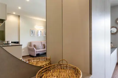 a living room with wicker chairs and a table at Mali Apartments Balcony in Tirolo