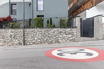 a stop sign on the side of a street at Mali Apartments Balcony in Tirolo