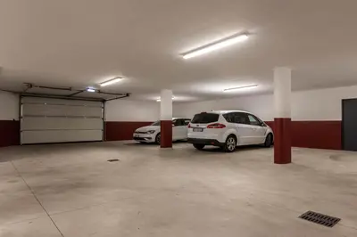 a garage with two cars parked in it at Mali Apartments Balcony in Tirolo