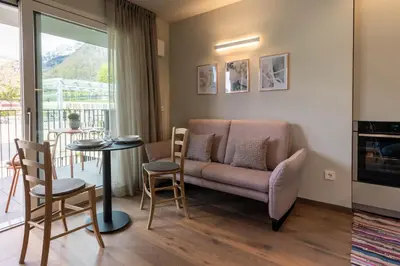 a living room with a couch and a table at Mali Apartments Balcony in Tirolo