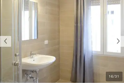 a bathroom with a sink and a shower curtain at Appartamento Bolzano Centro Talvera in Bolzano