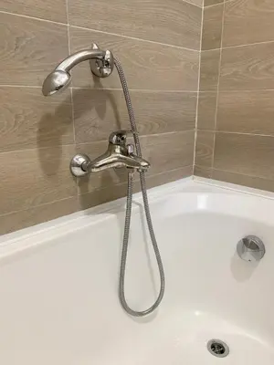 a bath tub with a faucet in a bathroom at Appartamento Bolzano Centro Talvera in Bolzano
