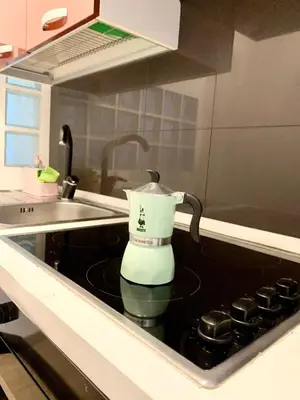 a coffee maker sitting on top of a stove in a kitchen at Appartamento Bolzano Centro Talvera in Bolzano