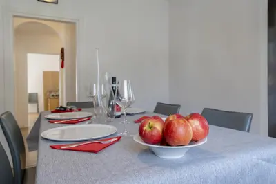 a table with a bowl of apples on top of it at Appartamenti Primiero in Fiera di Primiero
