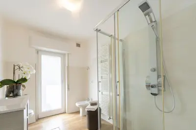 a bathroom with a shower with a glass door at Appartamenti Primiero in Fiera di Primiero