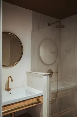 a bathroom with a sink and a shower and a mirror at Schnitzbichlhof in Lana