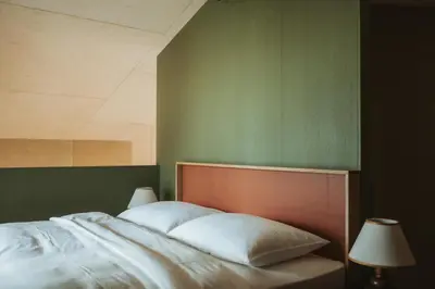 a bedroom with a bed with two pillows at Schnitzbichlhof in Lana