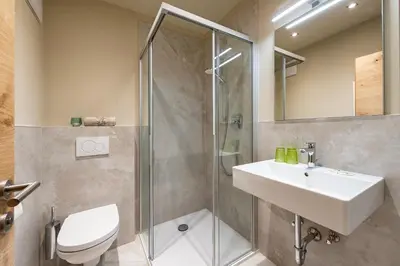 a bathroom with a shower and a sink and a toilet at Ursulas Idyll in Saltusio
