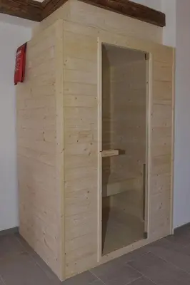 a wooden cabinet with a glass door in a room at Pignathof Castanea in Campodazzo