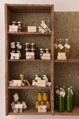 a shelf filled with lots of jars of food at Pignathof Castanea in Campodazzo