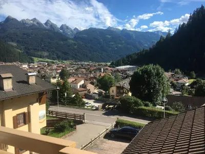 a view of a town with mountains in the background at Pragma Apartments - Appartamento Genziana in Predazzo