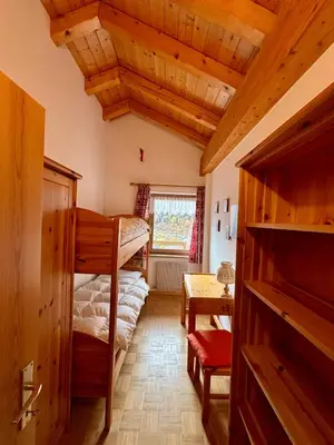 a room with two bunk beds and a window at Pragma Apartments - Appartamento Genziana in Predazzo