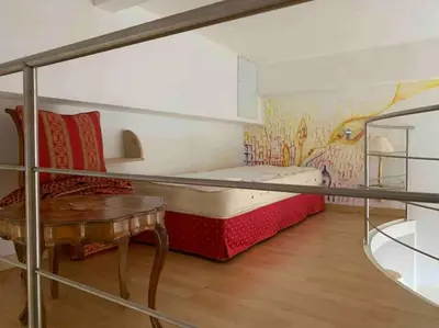 a small room with a bed and a table at Helles Apartment in historischer Villa in Merano