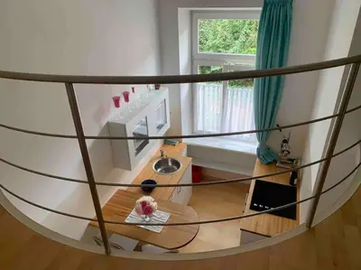a round room with a table and a window at Helles Apartment in historischer Villa in Merano
