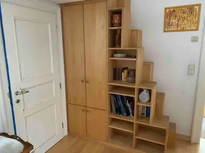 a room with a book shelf with books at Helles Apartment in historischer Villa in Merano