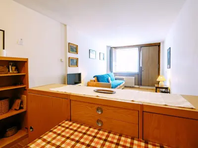 a large building with a mountain in the background at Apartment Solaria-2 by Interhome in Campestrin