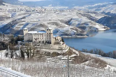 a castle on top of a hill with a body of water at APPARTAMENTO TOMA MIHAELA in Tres