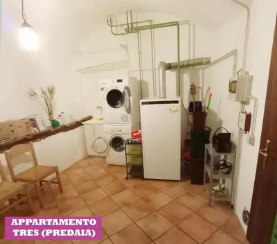 a kitchen with a refrigerator and a microwave at APPARTAMENTO TOMA MIHAELA in Tres