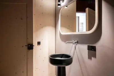 a bathroom with a black sink and a mirror at Rappersbühl in Collalbo