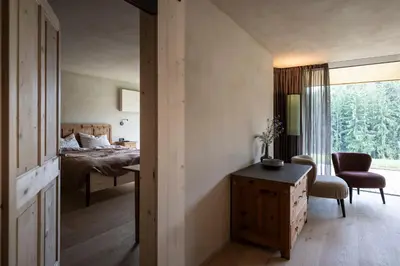 a bedroom with a bed and a desk and a window at Rappersbühl in Collalbo
