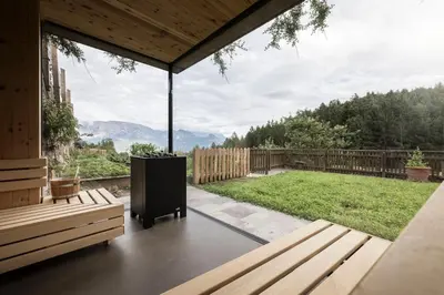 a screened in porch with a view of a yard at Rappersbühl in Collalbo
