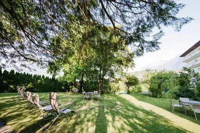 a group of chairs and tables in a yard at Gästehaus Salvatorianerinnen in Merano