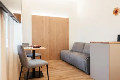 a living room with a couch and a table at Gästehaus Salvatorianerinnen in Merano
