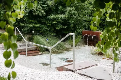 a metal object in the sand in a garden at Gästehaus Salvatorianerinnen in Merano