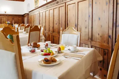 a long table with plates of food on it at Gästehaus Salvatorianerinnen in Merano