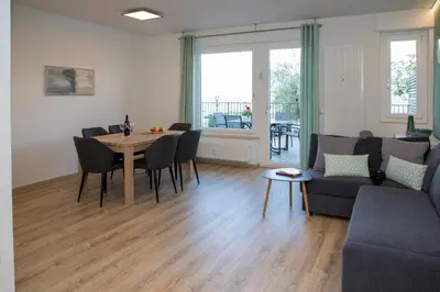 a living room with a table and a couch at Appartement 7 in Caldaro