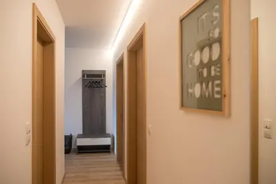 a hallway with a wall with a picture on the wall at Appartement 7 in Caldaro