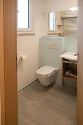 a bathroom with a toilet and a sink at Appartement 7 in Caldaro
