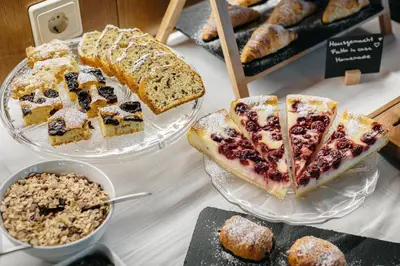 a table with different types of bread and pastries at Garni Rives in Ortisei