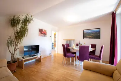 a living room with a table and a dining room at Melaniesguesthouse 4 Zimmerwohnung in Caldaro