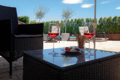 a table with two glasses of red wine on it at Melaniesguesthouse 4 Zimmerwohnung in Caldaro