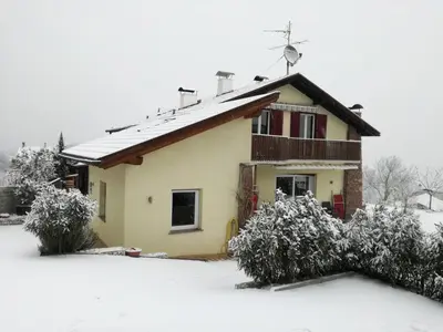 a house covered in snow with at Melaniesguesthouse 4 Zimmerwohnung in Caldaro