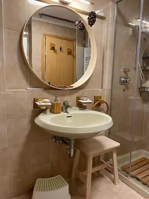 a bathroom with a sink and a mirror and a shower at El Fienil in Mazzin