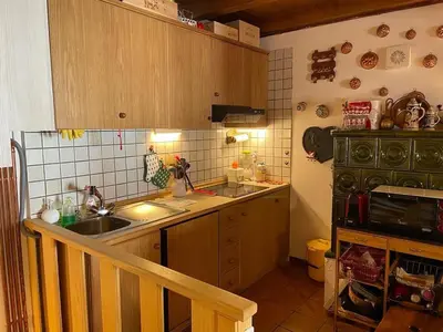 a small kitchen with a sink and a stove at El Fienil in Mazzin