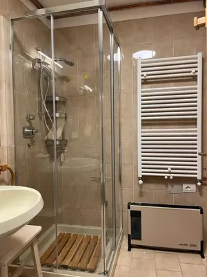 a glass shower in a bathroom with a sink at El Fienil in Mazzin