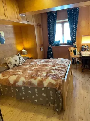 a bedroom with a large bed and a table at El Fienil in Mazzin