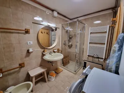 a bathroom with a sink and a shower and a toilet at El Fienil in Mazzin