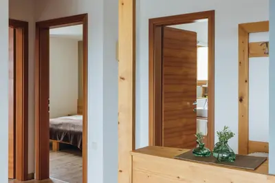 a room with a mirror and a bedroom with a bed at Mandlerhof in Verano