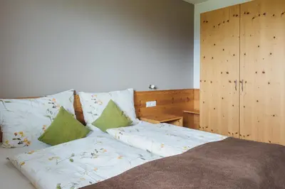 a bedroom with a bed with pillows on it at Mandlerhof in Verano