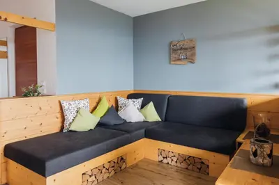 a couch with pillows on it in a room at Mandlerhof in Verano