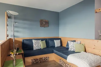 a blue couch with pillows on it in a room at Mandlerhof in Verano