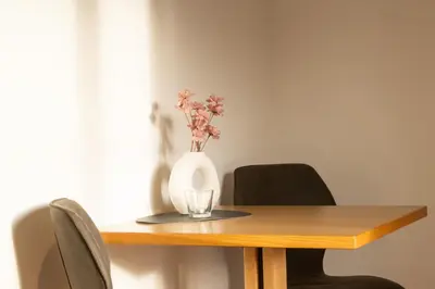 a vase with flowers in it sitting on a table at Wolkanhof Vineyard Apartments in Appiano sulla Strada del Vino