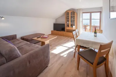 a living room with a couch and a table at Wolkanhof Vineyard Apartments in Appiano sulla Strada del Vino